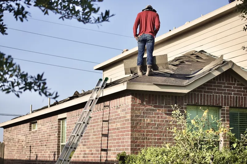 Professional roofer working on a residential roof in Northeast Central Loveland